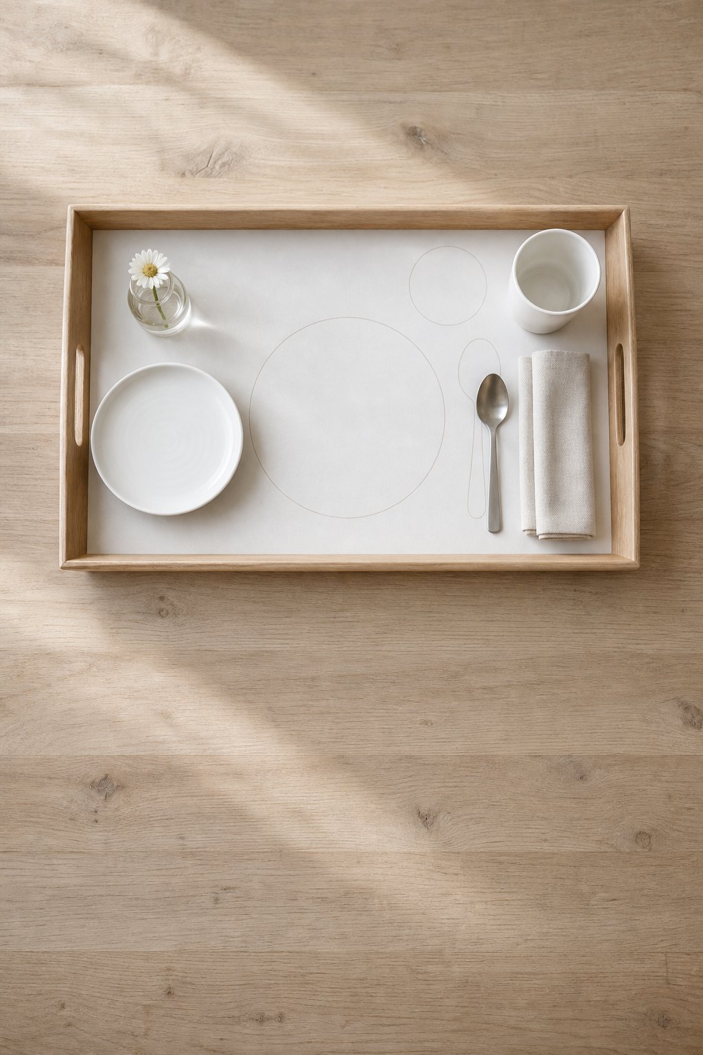 Tablett mit einem Platzset aus Papier mit Umrissen von Teller, Besteck und Becher